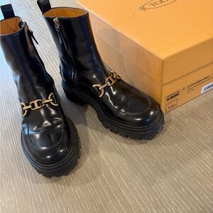 Tod's Black Leather Lug-Sole Boots with Gold Hardware